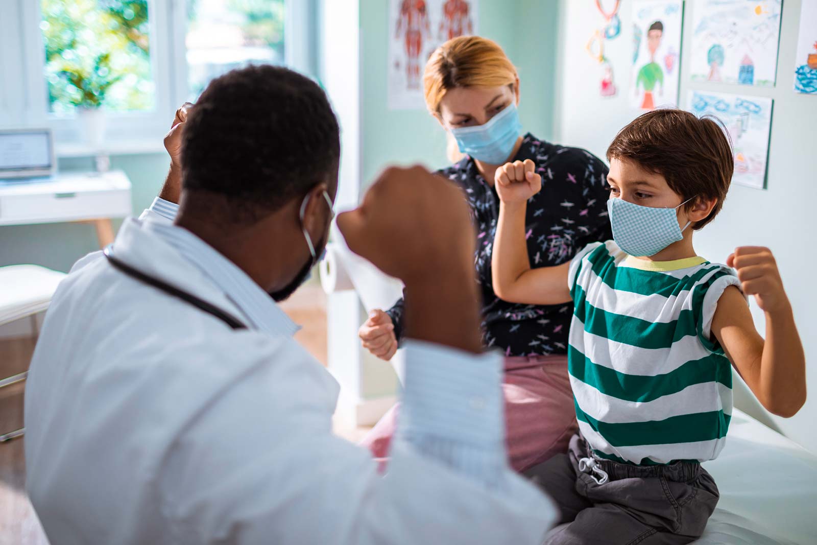 Doctor and patient wearing masks during in-person appointment