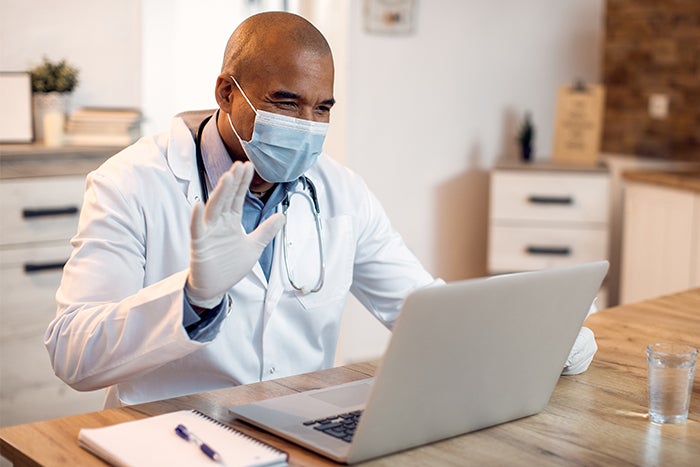Provider waves to patient during telehealth visit