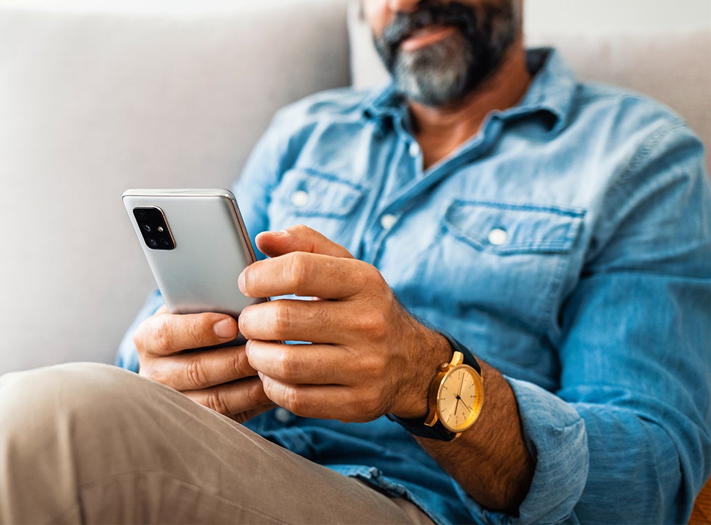 man answering a survey on his mobile phone