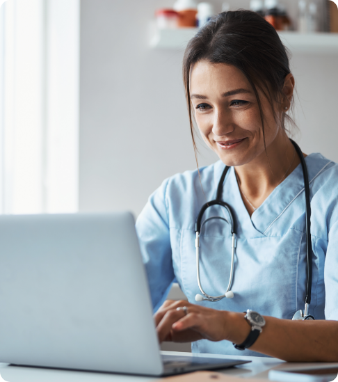 Nurse on computer reviewing patient analytics