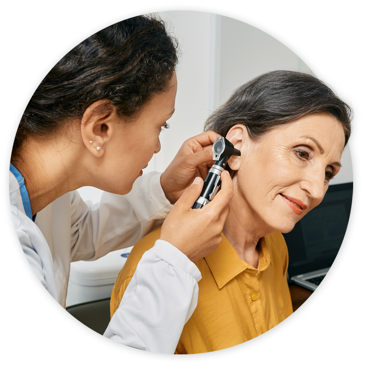 Otolaryngologist examining female patient's ears