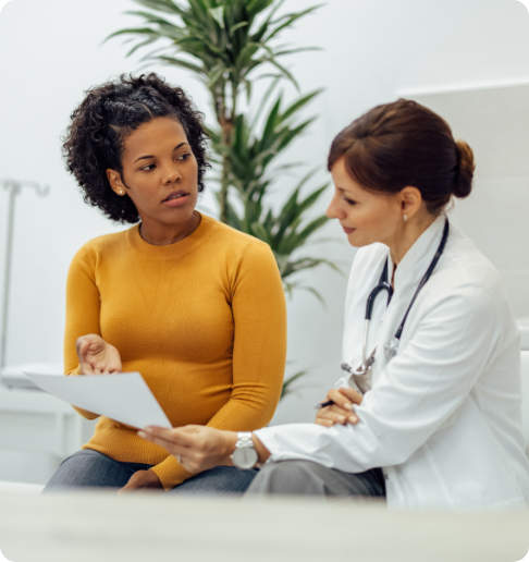 Female patient consulting with doctor during appointment