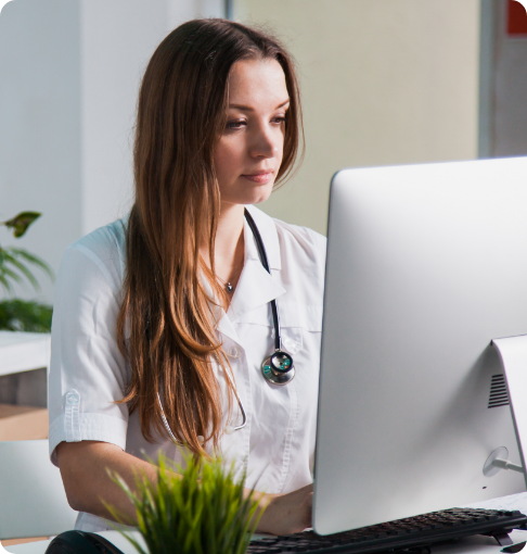 Nurse on computer reviewing patient analytics