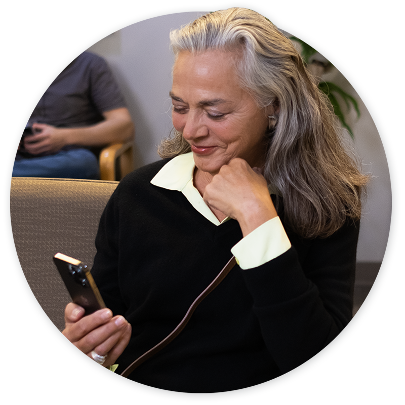 Older woman on mobile phone in waiting room