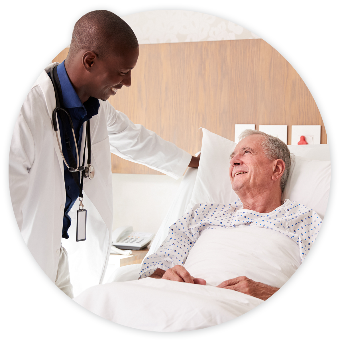 Doctor talking to cardiology patient in hospital bed