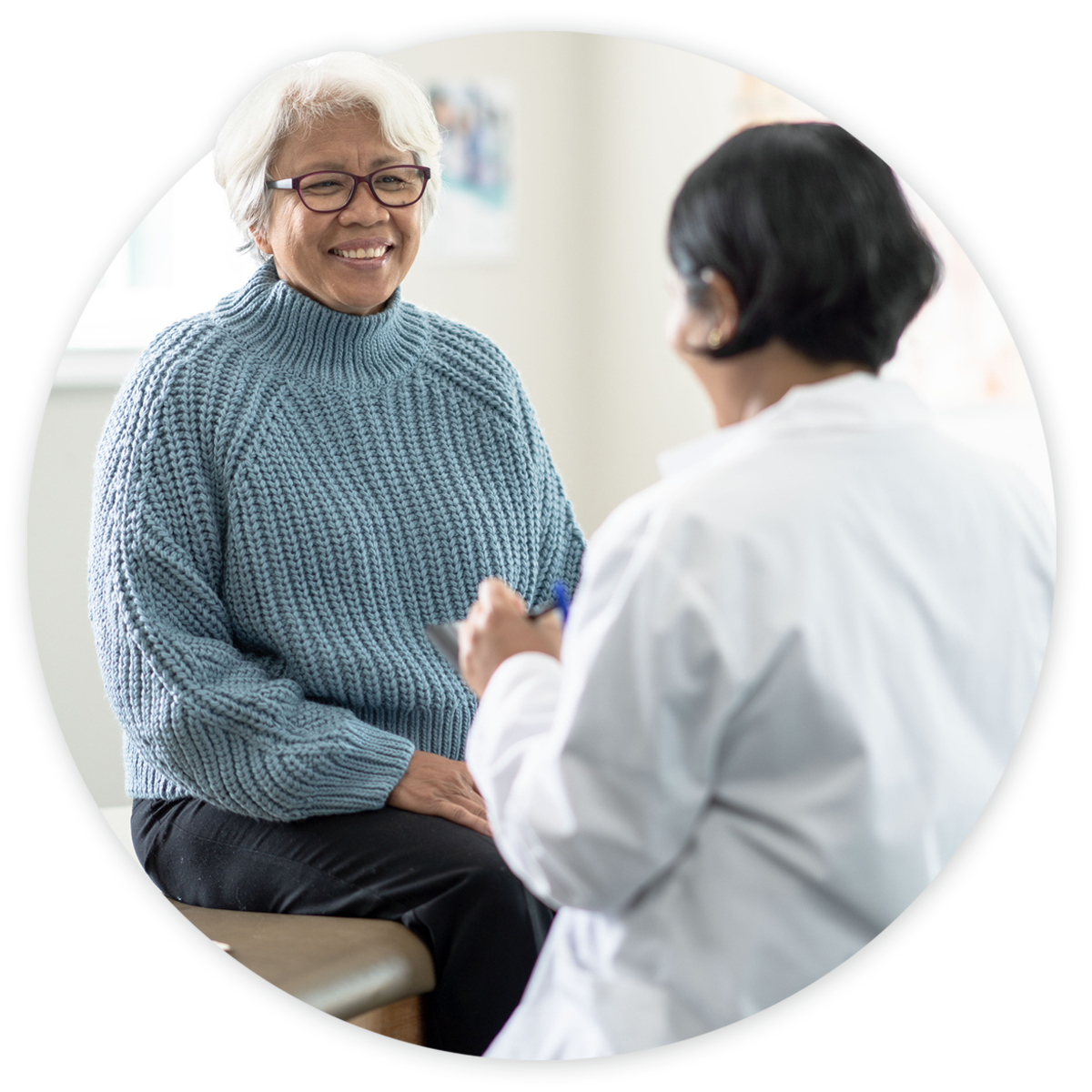 FQHC_hero Doctor talking to patient during an exam at an FQHC