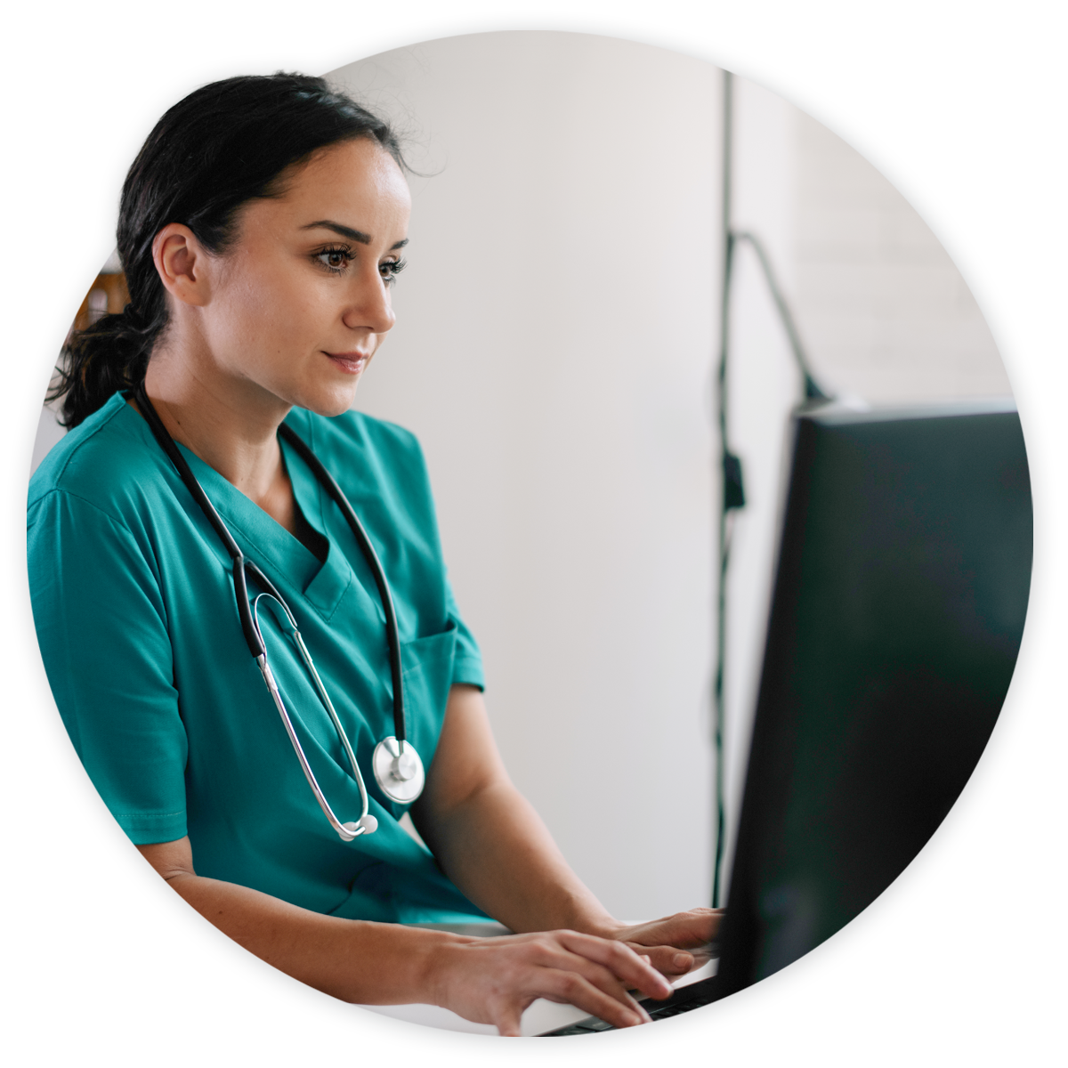 Integrations-hero Nurse on computer making updates to PM and EHR system