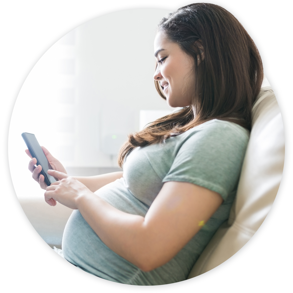 Pregnant woman making OB/GYN appointment on mobile phone
