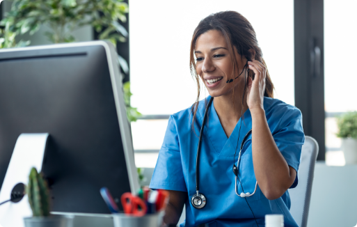 PAM_overview_image2 Nurse talking on headset while working on computer at front desk