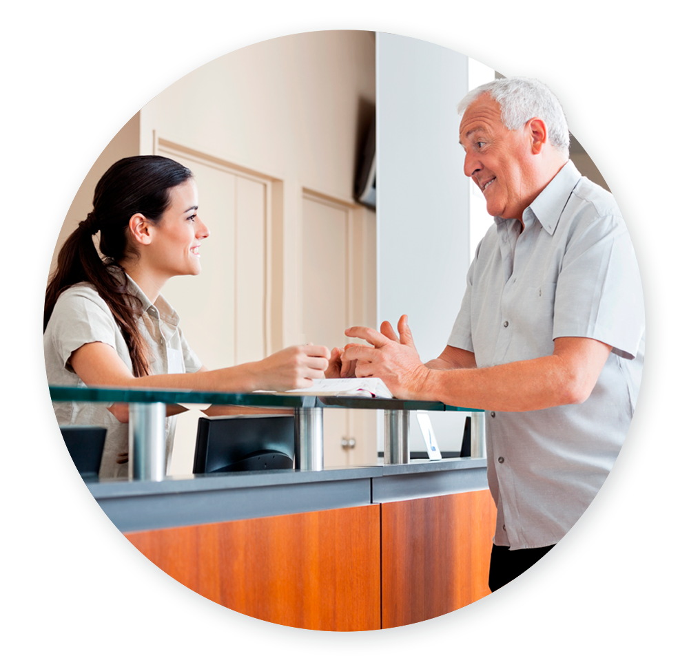 Hospital receptionist talking to happy patient