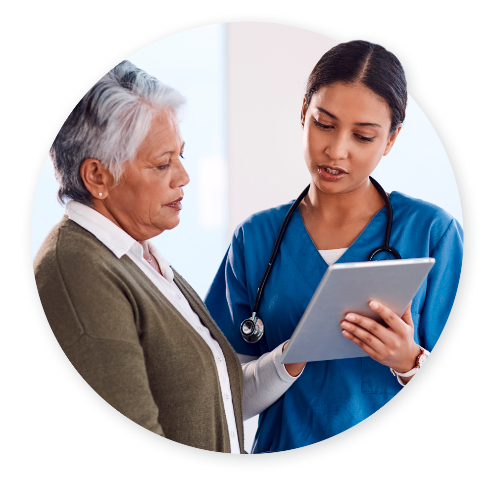 Nurse talking to older patient and showing information on tablet