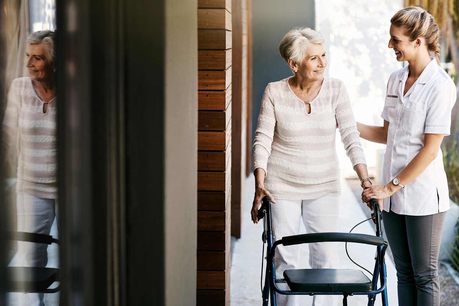 Nurse helping patient with a walker