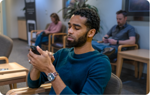 Man on phone in waiting room Man on phone in waiting room