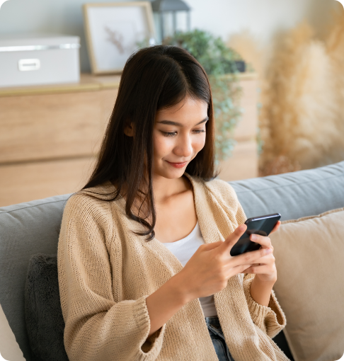 Girl on couch looking at mobile phone 