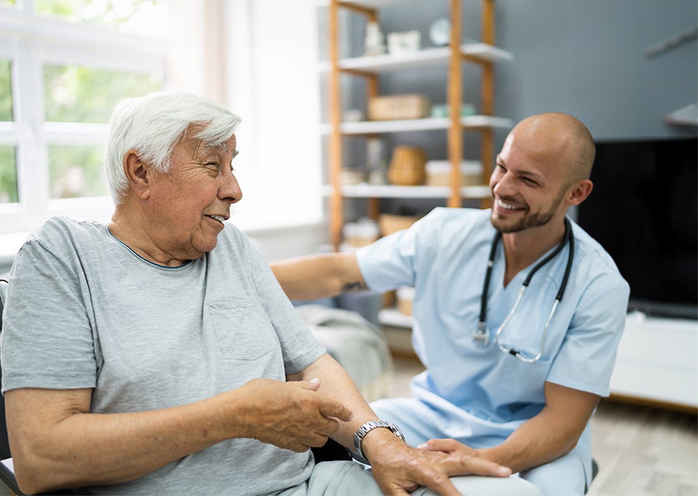 doctor speaking with older patient in an exam room