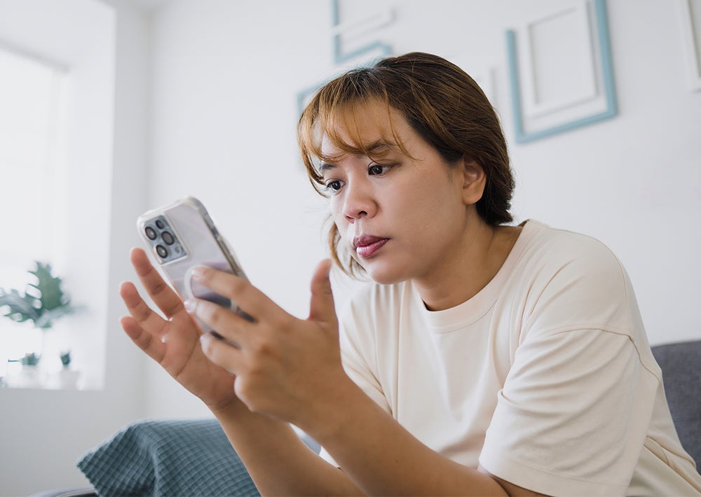 A photo of a person taking a survey on their iPhone.