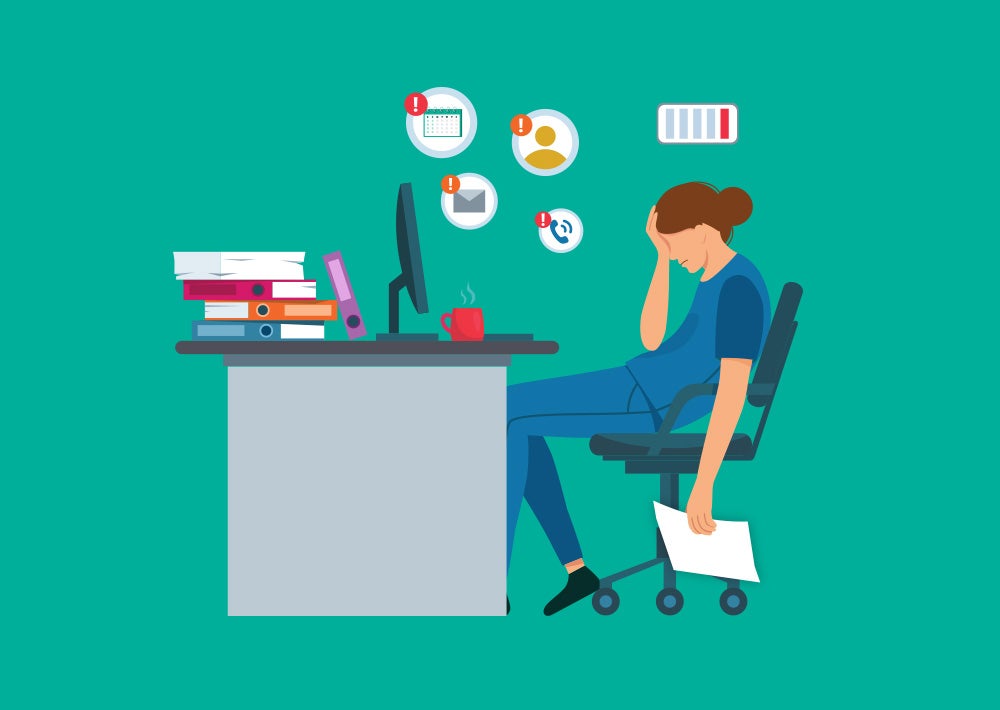 An illustration of a person sitting at a desk, feeling burnt out and stressed.