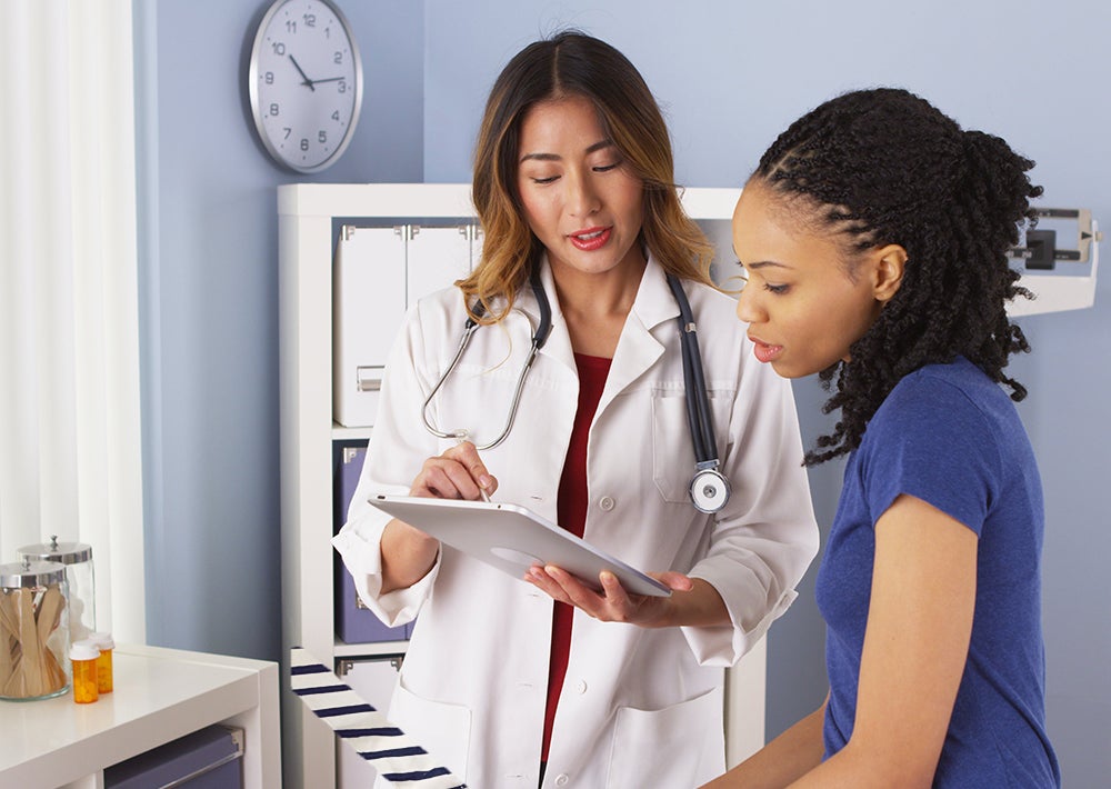 Doctor talking to patient in exam room