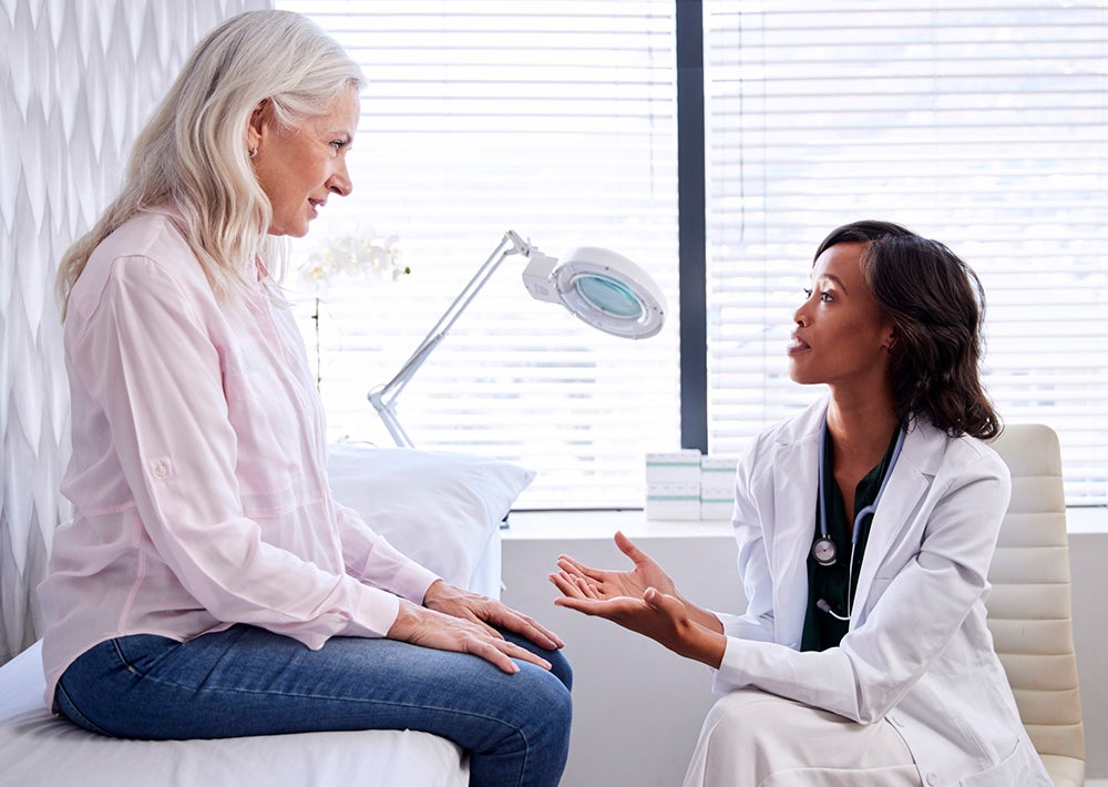 Doctor talking to patient in exam room