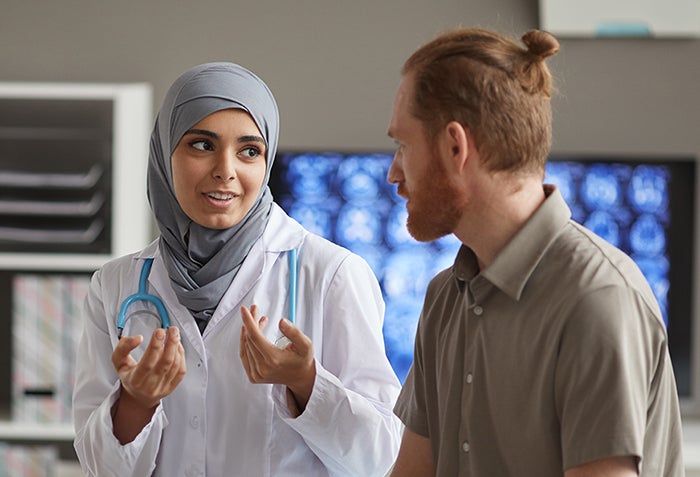 Doctor talking to patient in exam room