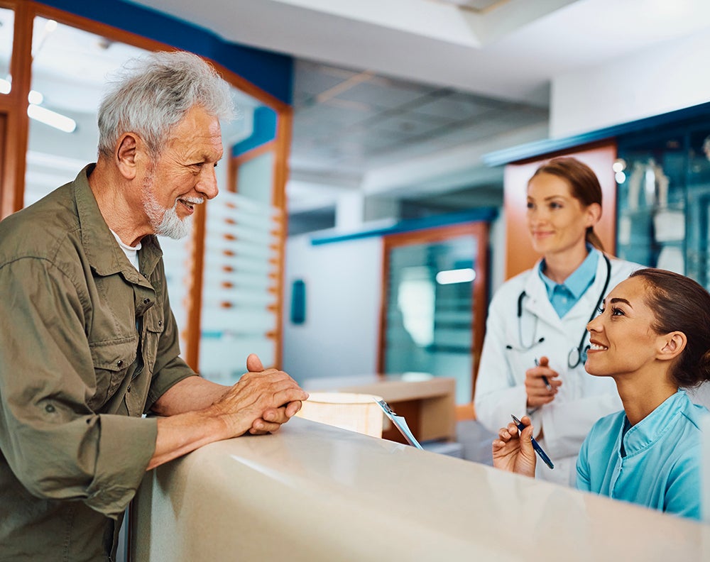 Man talking with front desk staff