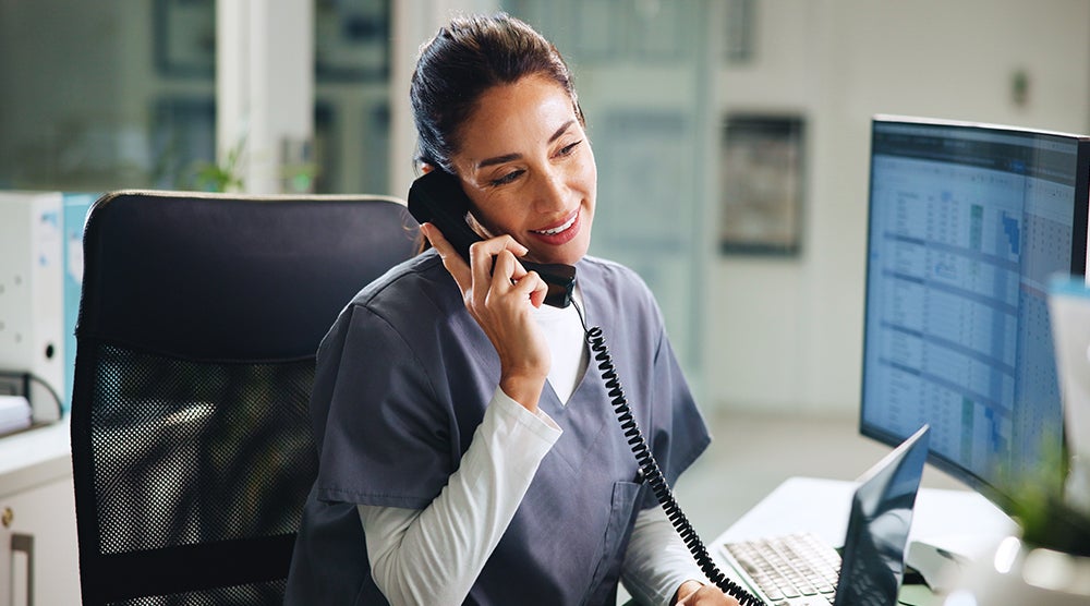 Front desk staffer on phone