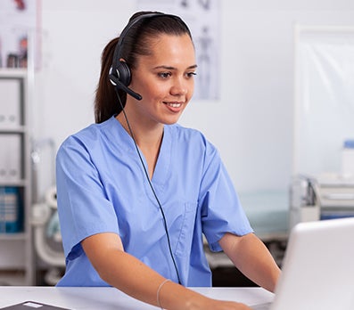 PhreesiaVoiceAI-tab7 Nurse with headset at computer