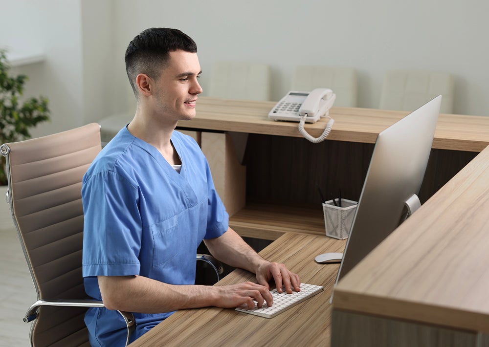 Healthcare worker sitting at desk with computer