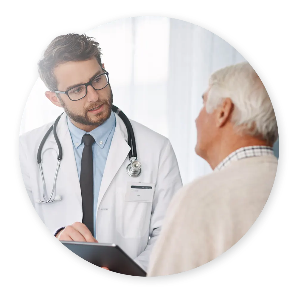 Urologist talking with older, male patient