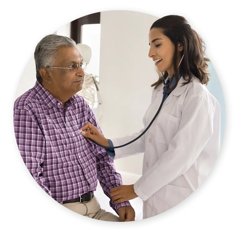 Doctor listening to patients heart with stethoscope