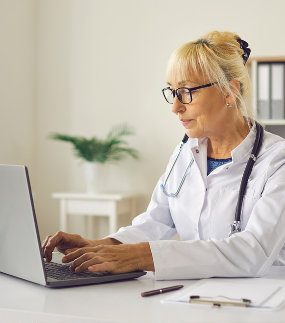 Doctor checking E&B on laptop