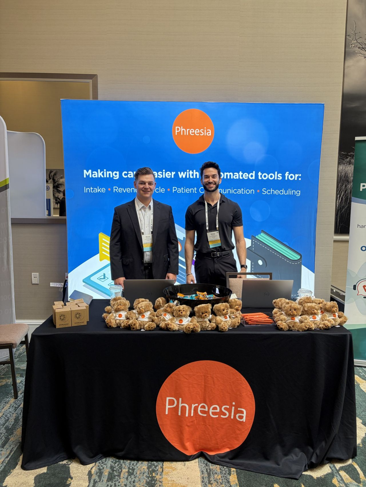 Two employees at Phreesia booth at OP Engage conference