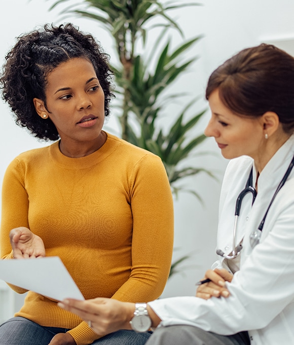 Black female patient talking with female doctor