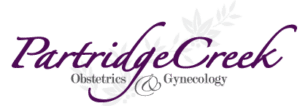 Partridge Creek Obstetrics & Gynecology logo in purple text with decorative leaf flourishes